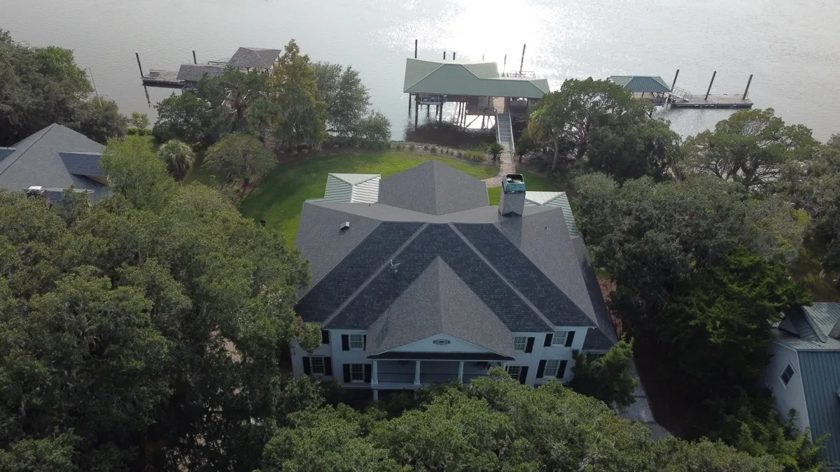 A residential roof replacement in progress on a fall day