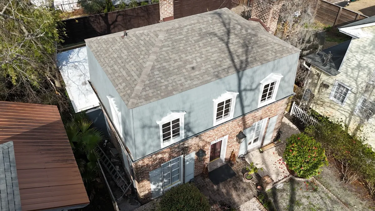 Savannah brick colonial with a new architectural shingle roof on East 48th Street