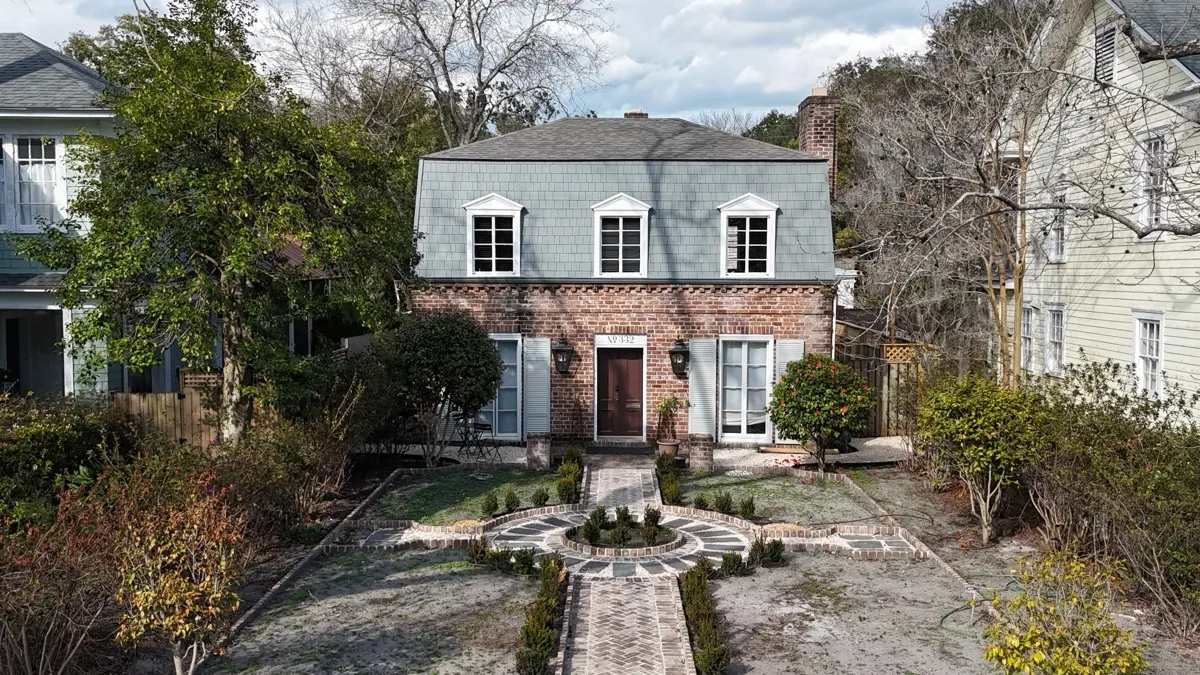 Roofline and facade detail of a Savannah brick colonial on East 48th Street