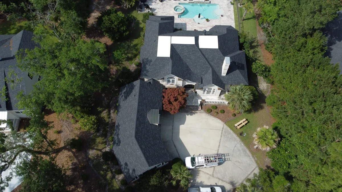 Aerial of a Skidaway Island estate with a new shingle roof among live oaks